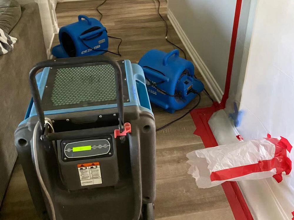 Close-up of a commercial dehumidifier with the work zone marked in red tape
