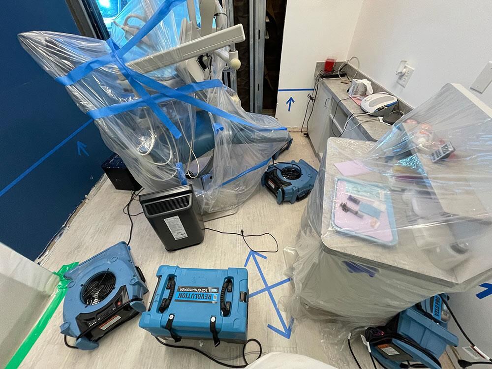 Dental equipment wrapped in plastic before water damage work begins